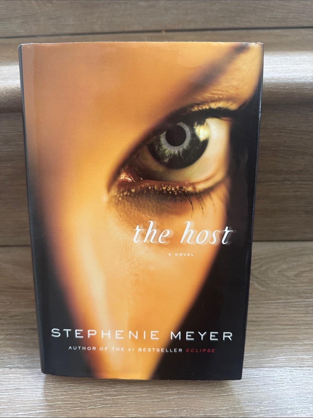 Chronicle Books The Host Hardcover with Eye Cover Art - Brown, Black, Gold